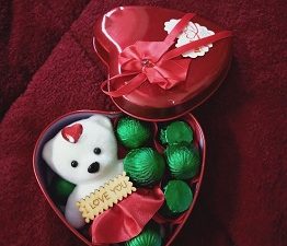 Red heart shaped box with teddy